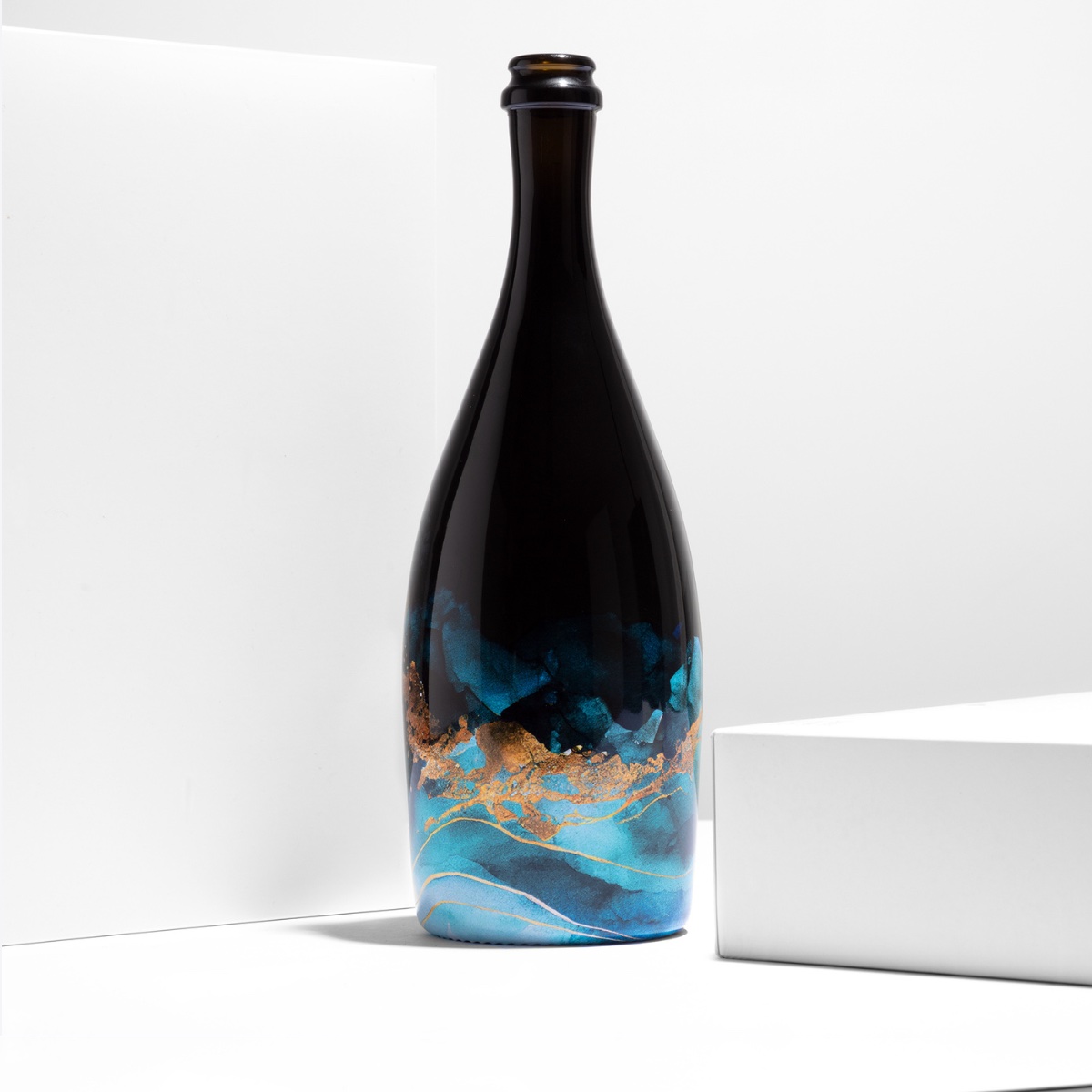 Partial coverage — artwork on the lower body of the bottle by ATIU