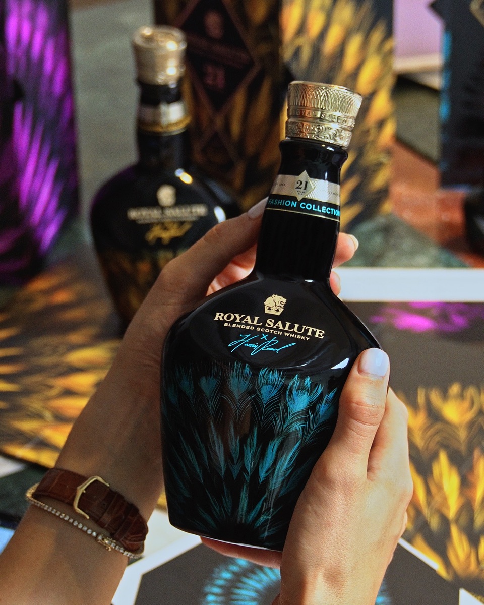 Fashion-edition whisky bottle held in hands — full-body sublimation on glass